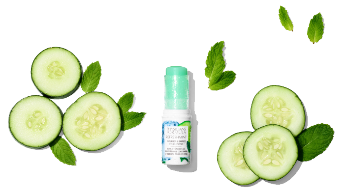 Cucumber slices and a bottle of Physicians Formula skin care product on a white background
